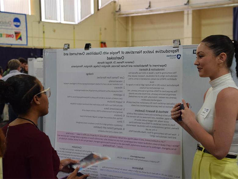 student presenting poster at ACURA fair